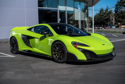 A vivid green McLaren 675LT supercar parked outside, showcased as an HD PC desktop wallpaper and background.