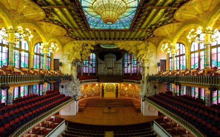 Interior view of a stunning music palace in Barcelona, Spain, showcasing ornate architecture, vibrant stained glass, and rows of red seats, captured in vibrant 4K Ultra HD.