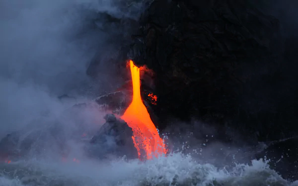A vivid 4K Ultra HD wallpaper capturing molten lava flowing into the ocean, surrounded by billowing smoke and water spray at a volcanic site.