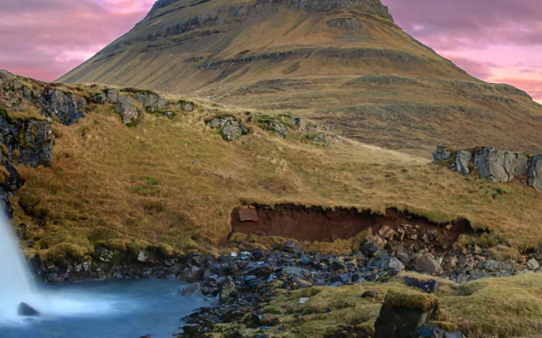 Panoramic HD wallpaper of Kirkjufoss waterfall with Kirkjufell mountain in Iceland, showcasing stunning natural landscape and vibrant sky.