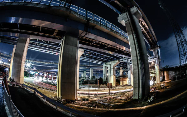 HD desktop wallpaper featuring a fisheye view of a city bridge by night with dynamic lighting and urban construction.