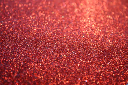 HD desktop wallpaper featuring a close-up of a red glittery surface, providing a vibrant and textured background.
