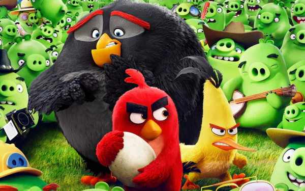 HD desktop wallpaper featuring characters from The Angry Birds Movie, including Red, Chuck, and Bomb alongside a crowd of green pigs. Vibrant and playful background.