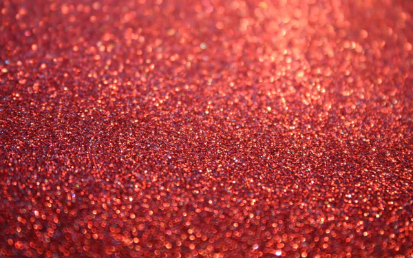 HD desktop wallpaper featuring a close-up of a red glittery surface, providing a vibrant and textured background.