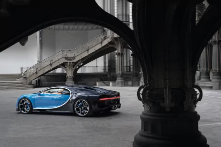 A sleek Bugatti Chiron in blue and black is showcased inside an industrial-style building, captured in stunning 4K Ultra HD as a PC desktop wallpaper.