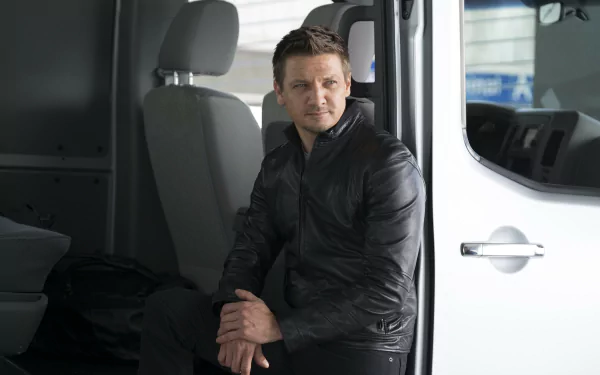 Clint Barton, portrayed by Jeremy Renner, sits pensively in a van, showcasing his character from Captain America: Civil War in this HD desktop wallpaper.