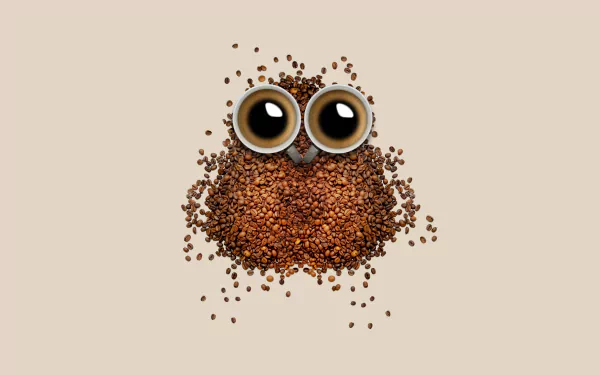 A whimsical arrangement of coffee beans forms an owl shape, with two cups of coffee at the top, creating a charming and artistic desktop wallpaper.