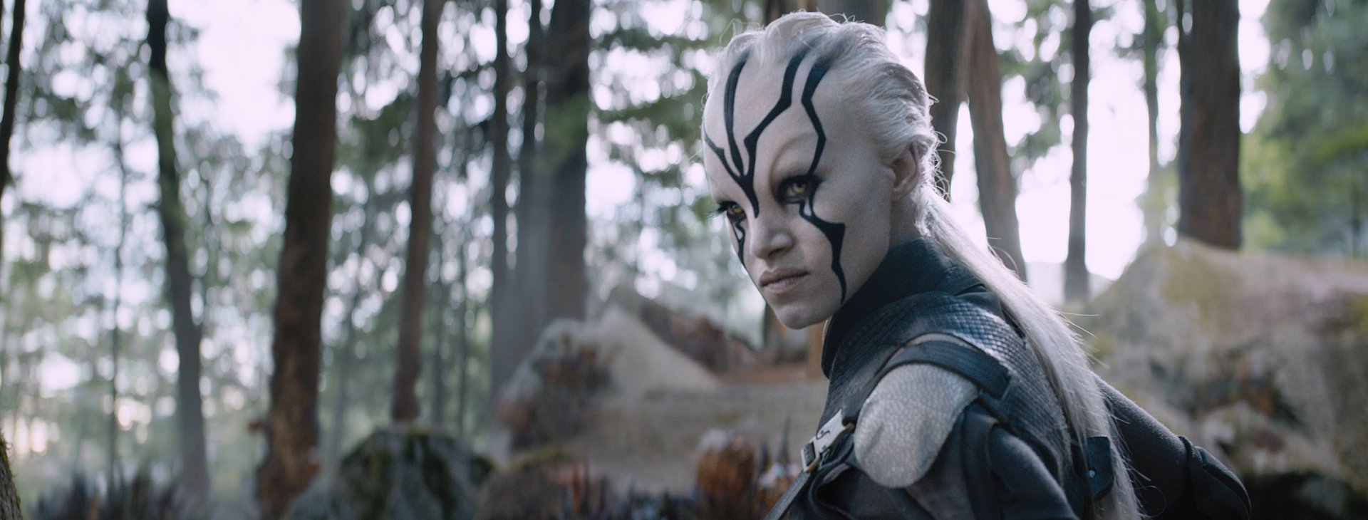 Sofia Boutella as Jaylah in Star Trek Beyond, featuring her fierce expression against a forest backdrop, captured in a high-definition desktop wallpaper.