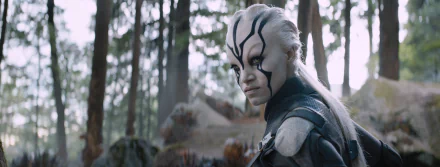 Sofia Boutella as Jaylah in Star Trek Beyond, featuring her fierce expression against a forest backdrop, captured in a high-definition desktop wallpaper.