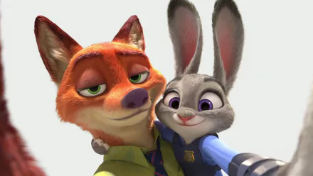 Nick Wilde and Judy Hopps from the movie Zootopia share a playful selfie, showcasing their friendship in this vibrant HD desktop wallpaper and background.