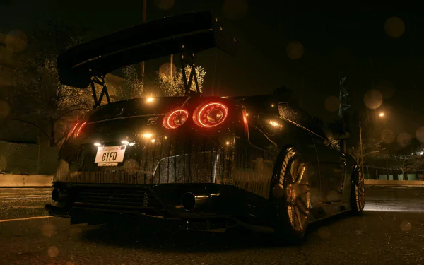 A sleek Nissan GT-R featured as a desktop wallpaper from the video game Need for Speed (2015), showcasing its striking design against a nighttime city backdrop.