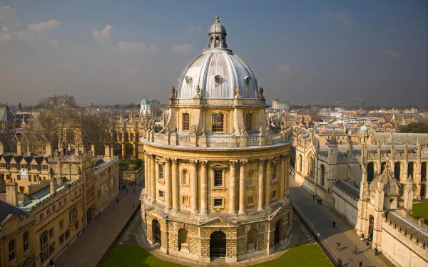 Ornate domed man-made building in Oxford, classical stone architecture and surrounding spires, HD PC desktop wallpaper and background.