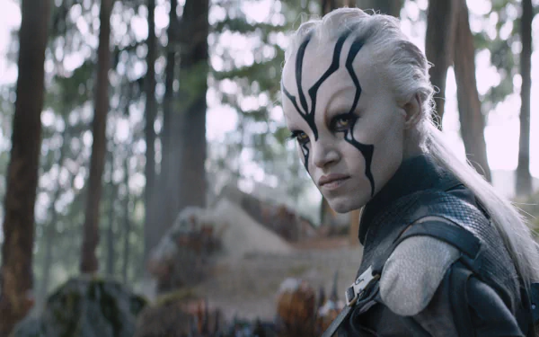 Sofia Boutella as Jaylah in Star Trek Beyond, featuring her fierce expression against a forest backdrop, captured in a high-definition desktop wallpaper.