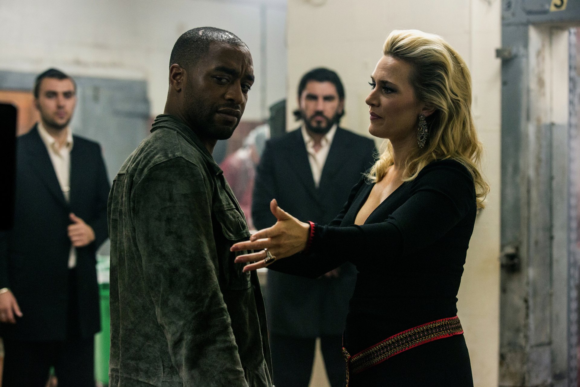 Kate Winslet and Chiwetel Ejiofor in a tense scene from the movie Triple 9. The image serves as a striking 4K Ultra HD wallpaper for fans of the film.