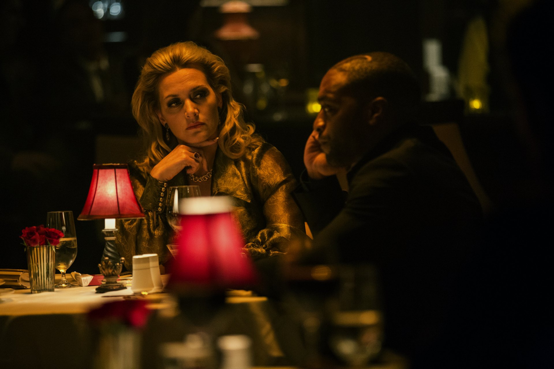 A dramatic scene from Triple 9 featuring Kate Winslet and Chiwetel Ejiofor at a dimly lit restaurant, capturing a moment of tension between the characters. 4K Ultra HD quality.