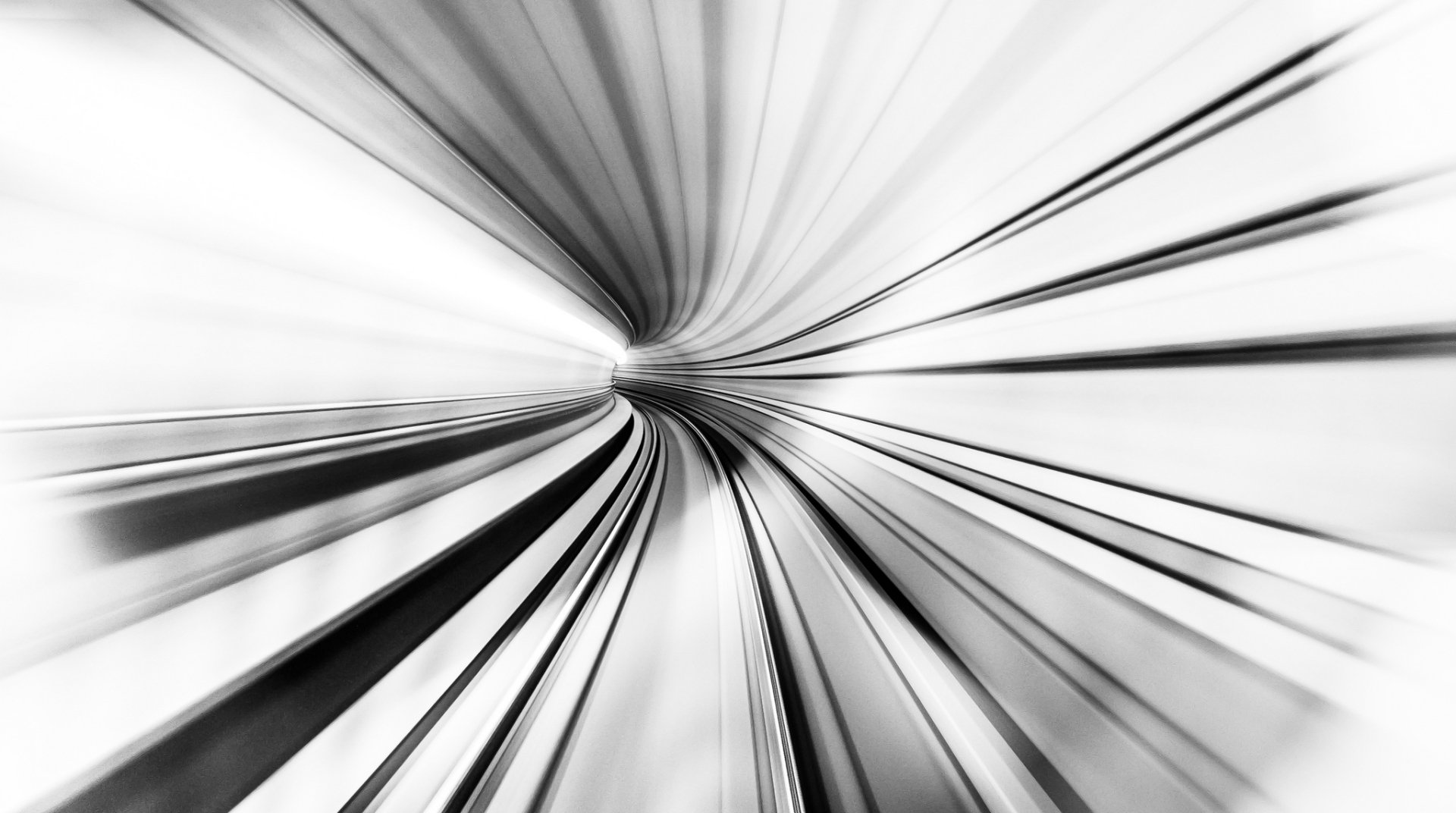 Black & white artistic tunnel abstraction in HD, radial motion blur converging to a vanishing point — high-resolution PC desktop wallpaper and background.