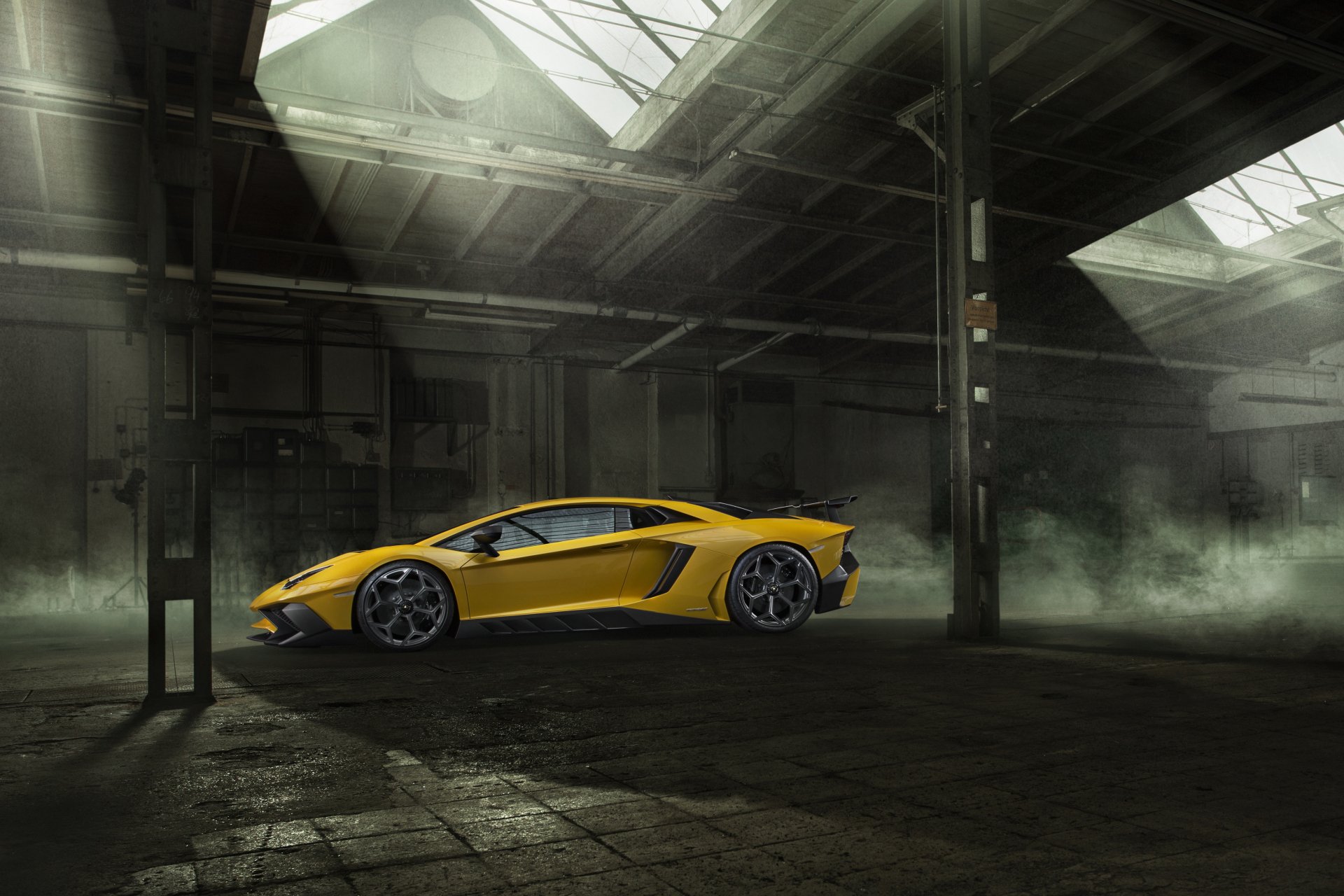 Yellow Lamborghini Aventador SV supercar showcased in a dimly lit industrial warehouse, captured in stunning 4K Ultra HD resolution.