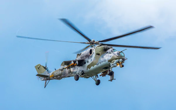 Mil Mi-24 military helicopter/aircraft in flight against a clear blue sky — 2K Quad HD PC desktop wallpaper and background