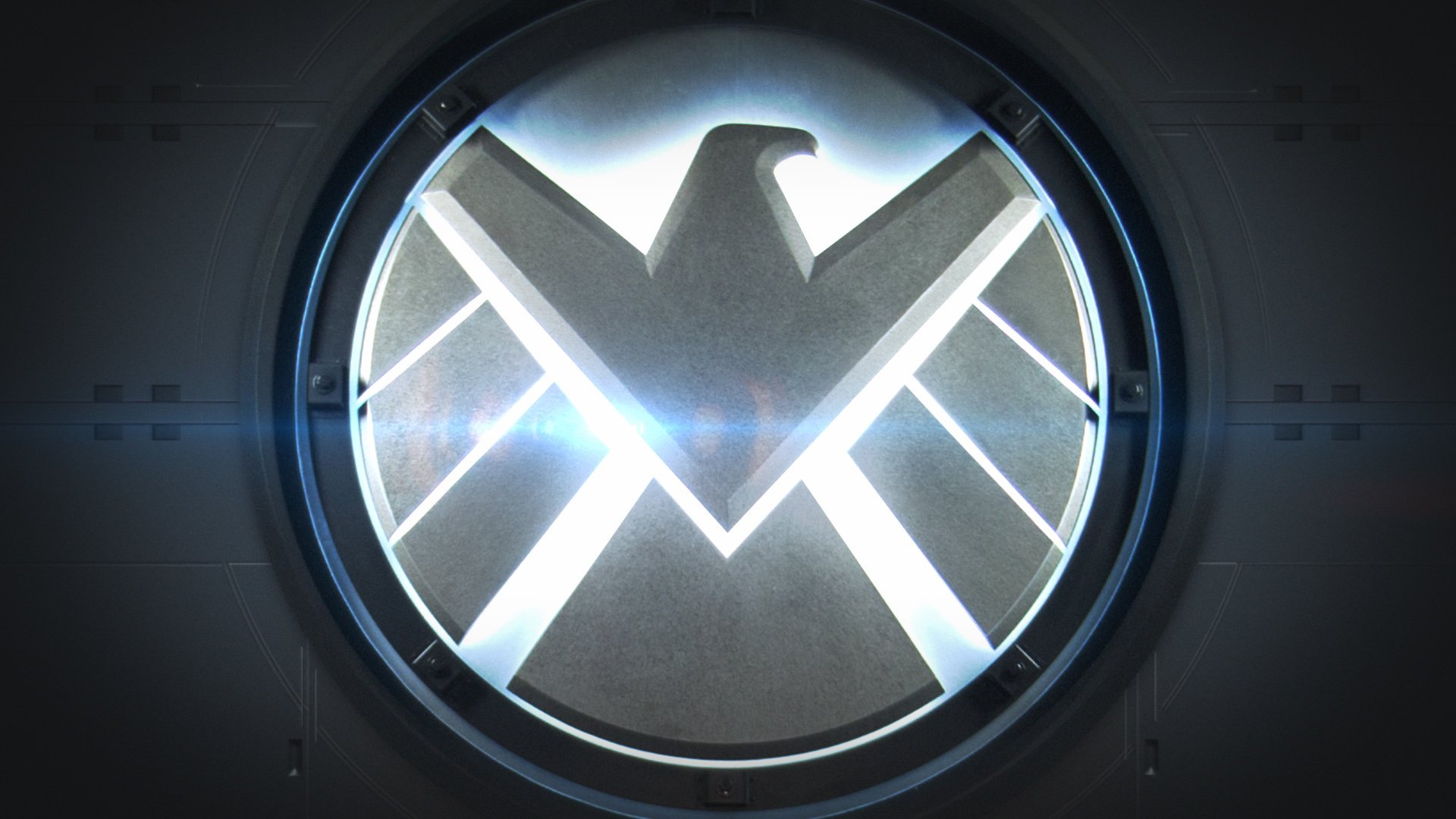 HD PC desktop wallpaper featuring the glowing logo of Agents of S.H.I.E.L.D. from the TV show, set against a dark background with light reflections.