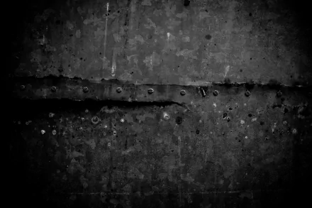 Abstract grunge monochrome concrete texture with scratches and rivets — 5K Ultra HD PC desktop wallpaper background.