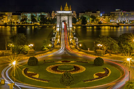 Night view of the illuminated Chain Bridge in Budapest, Hungary, showcasing the city skyline and river in a vibrant 4K Ultra HD desktop wallpaper.