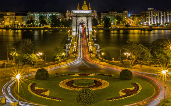 Night view of the illuminated Chain Bridge in Budapest, Hungary, showcasing the city skyline and river in a vibrant 4K Ultra HD desktop wallpaper.