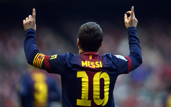Lionel Messi celebrates a goal, wearing the number 10 jersey and raising his arms, captured in an HD sports desktop wallpaper background.