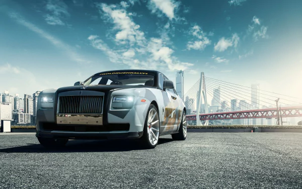 Silver Rolls-Royce Ghost parked on an urban street with a city skyline and bridge in the background, captured as an HD PC desktop wallpaper.