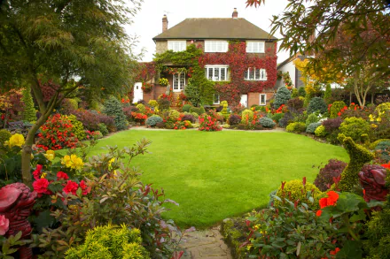 A vibrant English garden surrounds a charming man-made house, featuring lush greenery and colorful flowers in this HD PC desktop wallpaper and background.