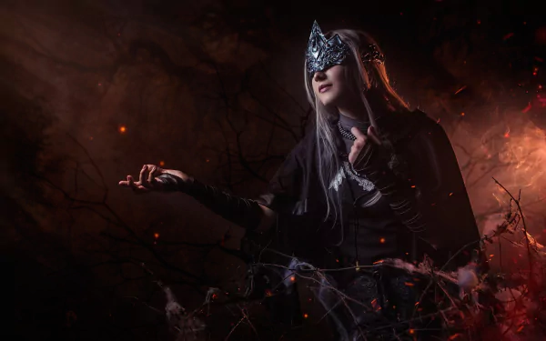 HD PC wallpaper featuring a woman cosplaying Fire Keeper from Dark Souls III, set against a dark, fiery background with glowing embers.