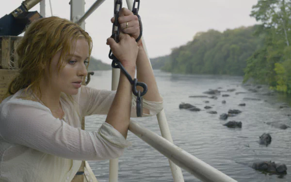 HD desktop wallpaper featuring Margot Robbie as Jane Porter in the movie The Legend of Tarzan, overlooking a river with a contemplative expression.