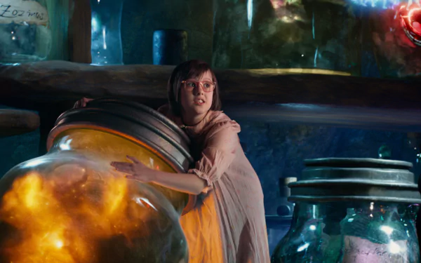 A scene from the movie The BFG (2016), featuring a young girl embracing a large, glowing jar amidst an enchanting collection of colorful containers in a magical setting.
