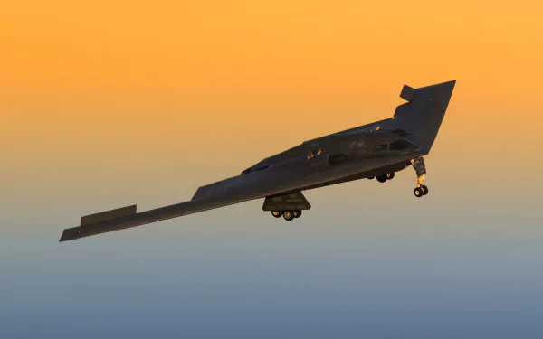 HD desktop wallpaper of a Northrop B-2 Spirit stealth bomber warplane in flight during sunset, showcasing its military air force aircraft design.