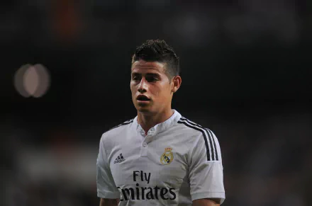 HD wallpaper featuring James Rodriguez in a Real Madrid C.F. jersey, showcasing the iconic soccer player's intensity and passion for the sport.