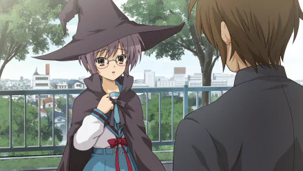 HD PC desktop wallpaper: Yuki Nagato from The Melancholy of Haruhi Suzumiya, in a witch hat and cloak, faces Kyon (Haruhi) on a tree-lined balcony with an anime cityscape background.