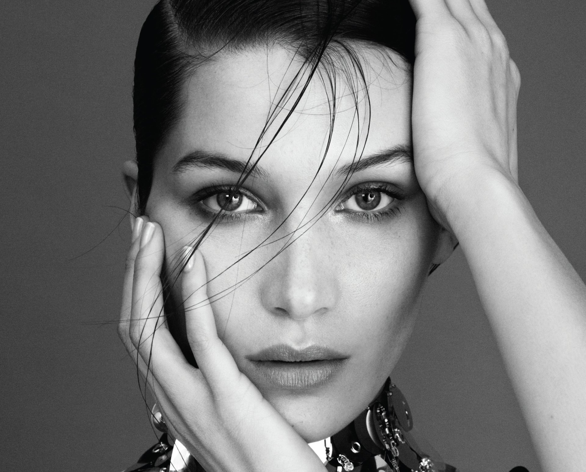 Black and white close-up portrait of brunette American model and celebrity Bella Hadid, featured as a high-definition PC desktop wallpaper and background.