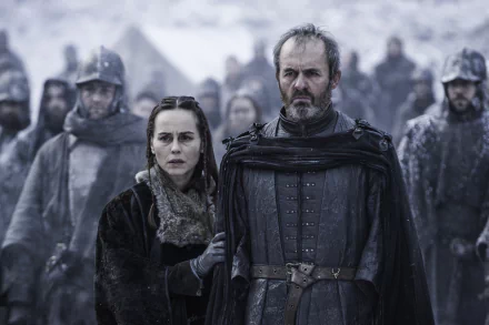 Stannis and Selyse Baratheon from the TV show Game of Thrones stand sternly in snow among troops — moody, detailed 4K PC desktop wallpaper/background.