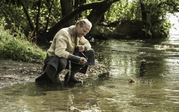 Jorah Mormont, portrayed by Iain Glen in Game of Thrones, sits by a riverbank in this detailed 4K Ultra HD PC desktop wallpaper and background.
