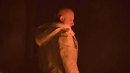 Vin Diesel as Xander Cage in a dramatic scene from xXx: Return of Xander Cage, captured in a high-definition PC desktop wallpaper. The moody lighting accentuates his silhouette.