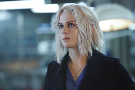 Liv Moore, portrayed by Rose McIver, stands in a lab setting, showcasing her character from the TV show iZombie. This image serves as an HD desktop wallpaper and background.