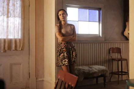 HD PC desktop wallpaper featuring Dominique Provost-Chalkley as Waverly Earp from the TV show Wynonna Earp, standing thoughtfully in a softly lit room.