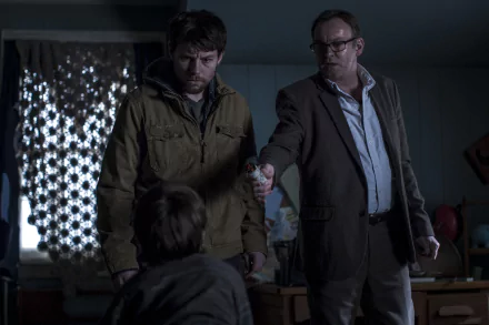 HD PC desktop wallpaper from the TV show Outcast: two men confront a child in a tense, shadowy room, one pointing while the other watches, moody blue-gray tones.