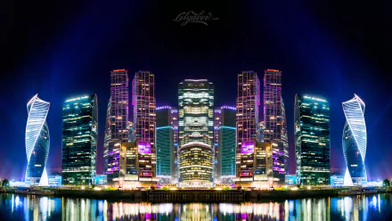 Colorful nighttime cityscape of Moscow, Russia, featuring illuminated modern skyscrapers reflected in water, captured in 4K Ultra HD.
