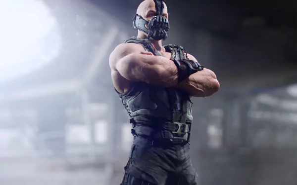 Bane from DC Comics stands confidently with crossed arms, portrayed in a high-definition wallpaper from The Dark Knight Rises, featuring a dramatic, atmospheric background.