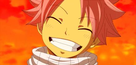 Natsu Dragneel from the anime Fairy Tail smiles brightly against a vibrant, fiery background, creating a stunning HD desktop wallpaper.