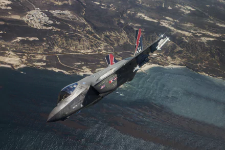 A Lockheed Martin F-35 Lightning II jet fighter soars above rugged coastline and water, captured in stunning 4K Ultra HD as a military warplane aircraft.