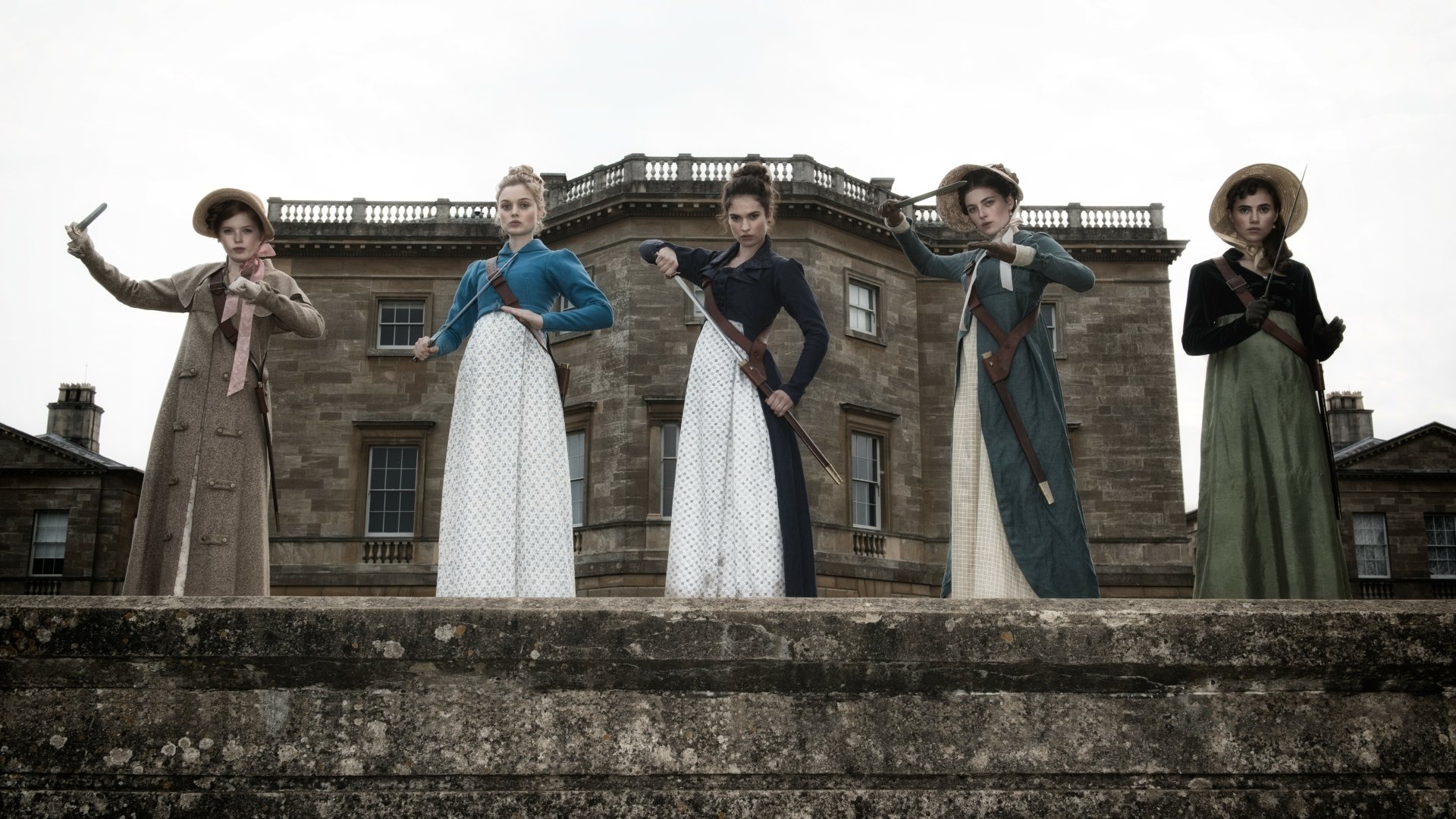 5K Ultra HD PC desktop wallpaper — movie still from Pride and Prejudice and Zombies: five Regency women in period dresses and hats, armed and posed on a stone terrace before a manor.