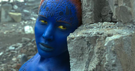 Mystique, portrayed by Jennifer Lawrence in X-Men: Apocalypse, showcases her striking blue appearance and intense expression against a rocky backdrop in this vibrant 8K Ultra HD image.