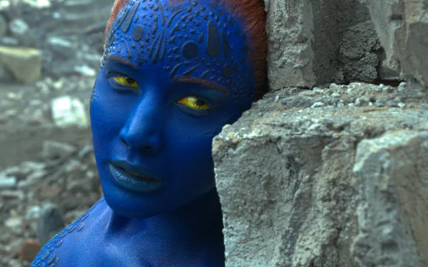 Mystique, portrayed by Jennifer Lawrence in X-Men: Apocalypse, showcases her striking blue appearance and intense expression against a rocky backdrop in this vibrant 8K Ultra HD image.