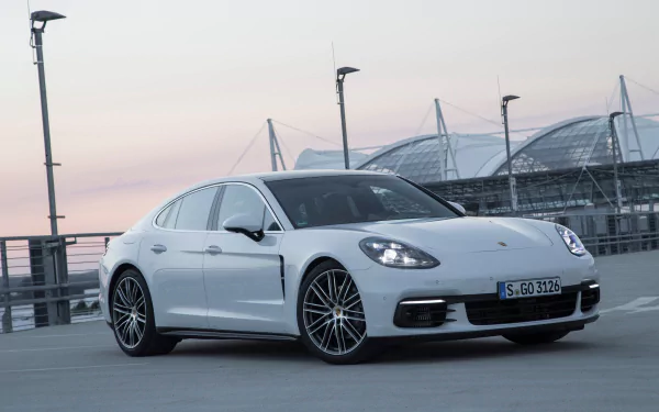 White Porsche Panamera 4S parked on a rooftop at dusk — high-resolution 4K Ultra HD PC desktop wallpaper and background featuring a sleek white Porsche Panamera.